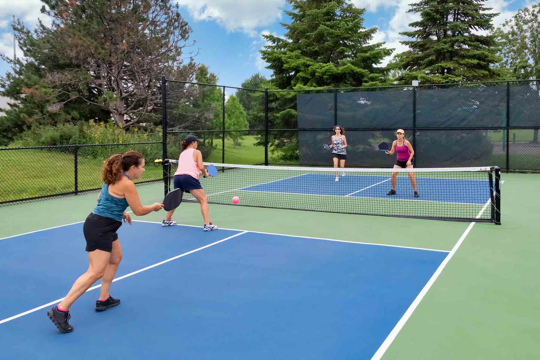 homeguide-players-in-a-doubles-game-on-a-pickleball-court